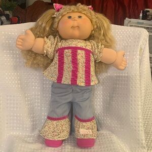 Play Along Cabbage Patch Kid from 2004, curly blonde pigtails and blue eyes.